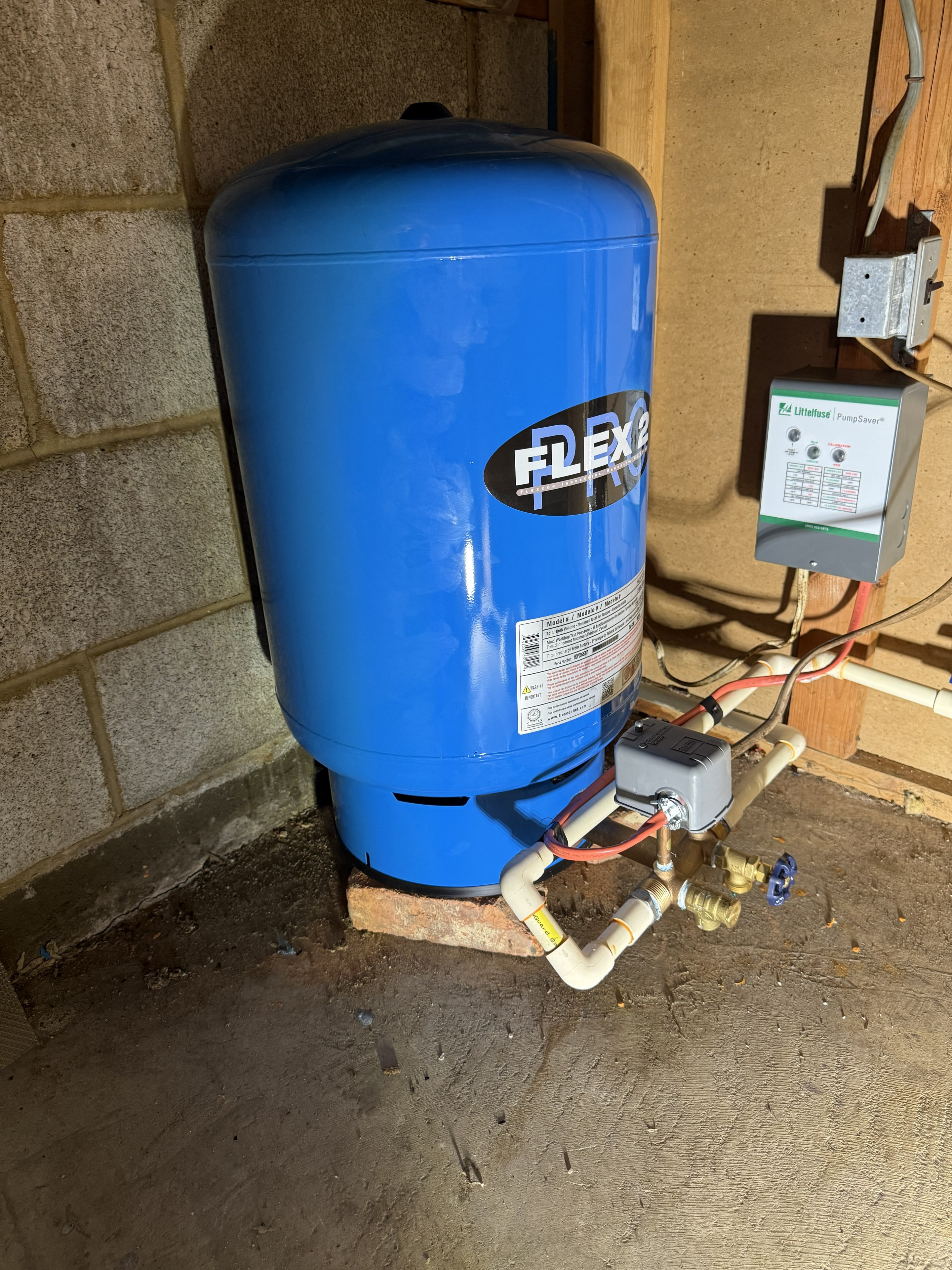 Flexcon pressure tank — angle view showing tank tee, gauge, and connections