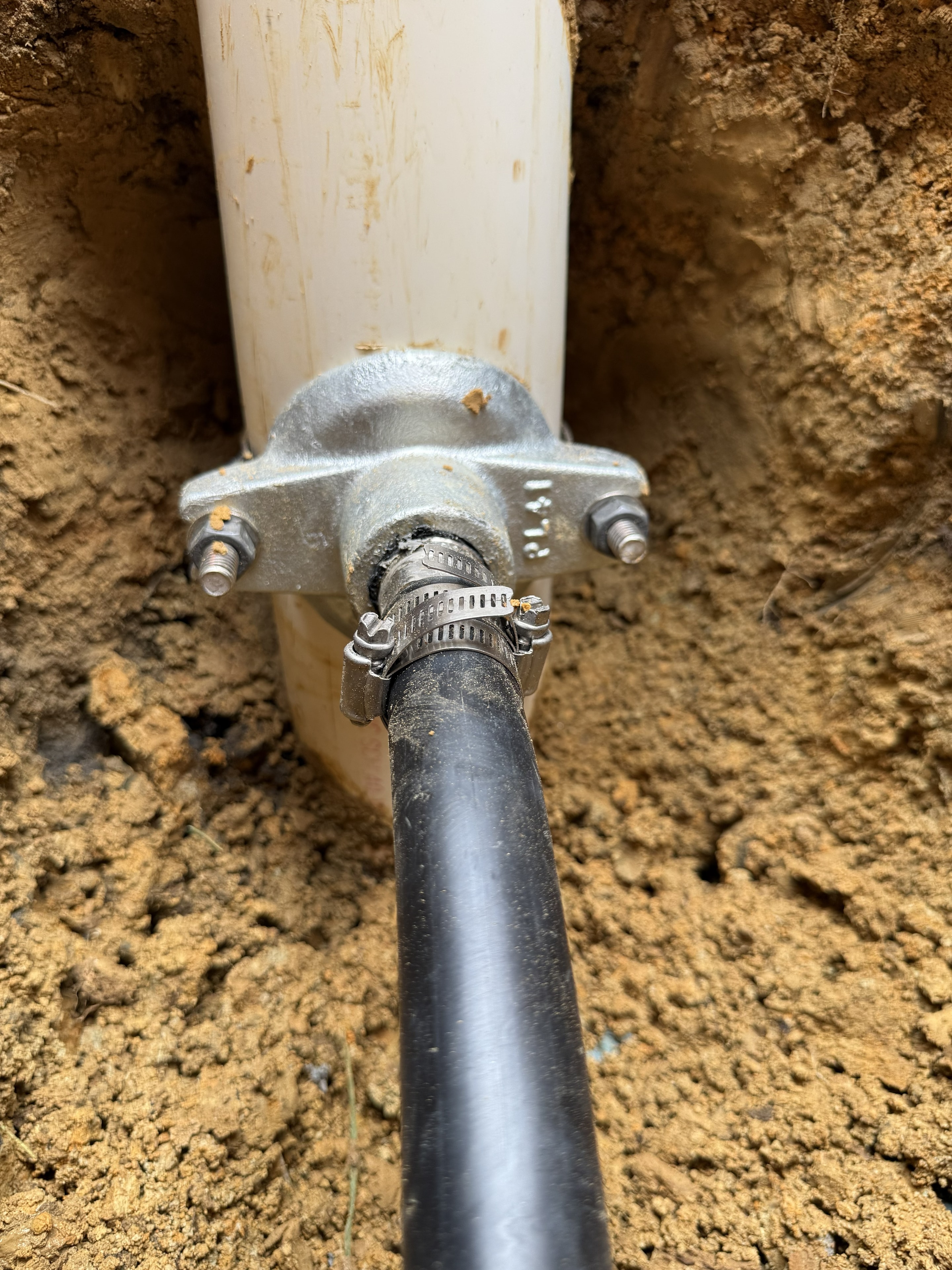 Pitless adapter close-up — pump casing entry point during replacement
