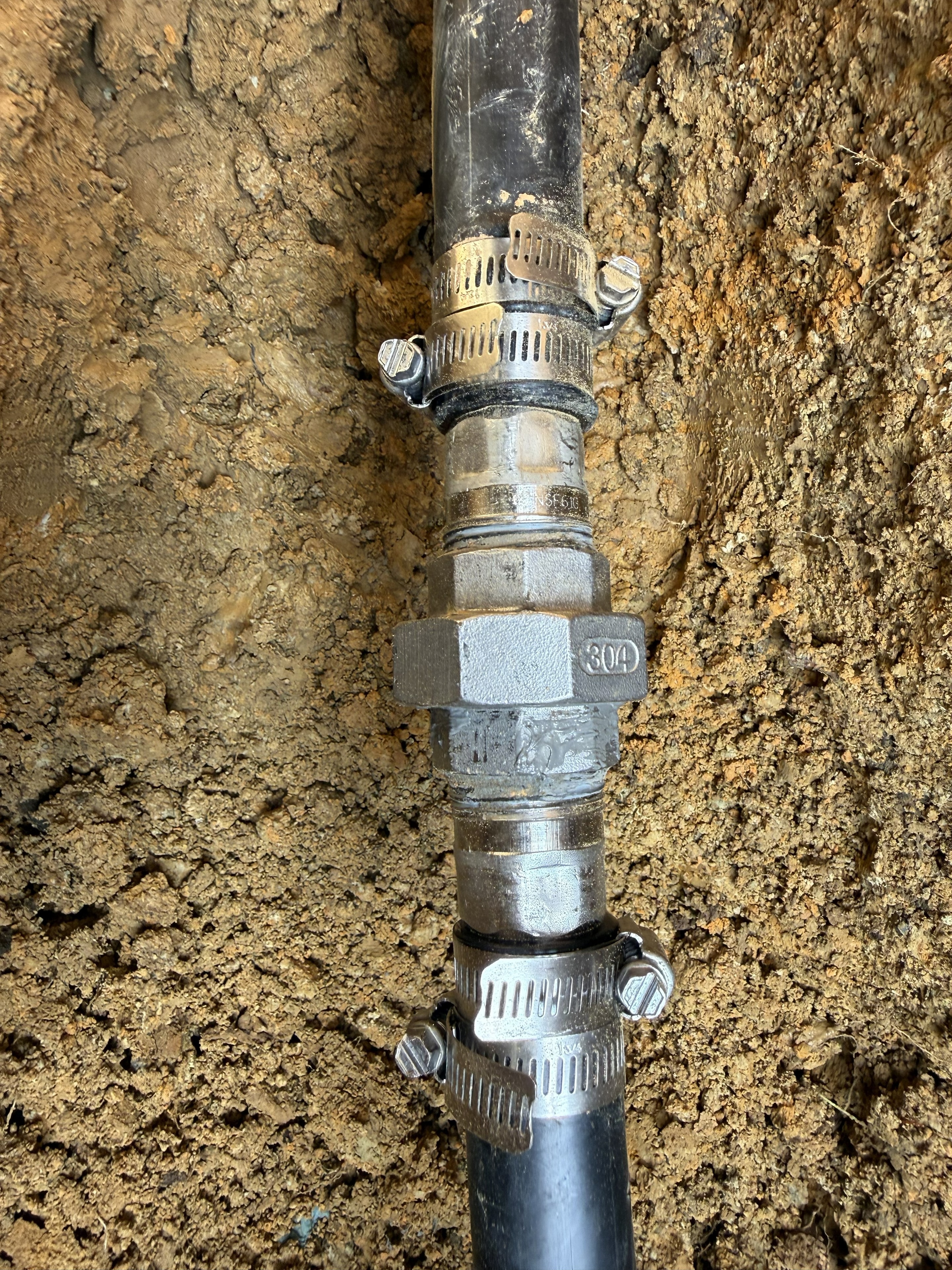 304 stainless well pump connector — hose clamps and fittings installed