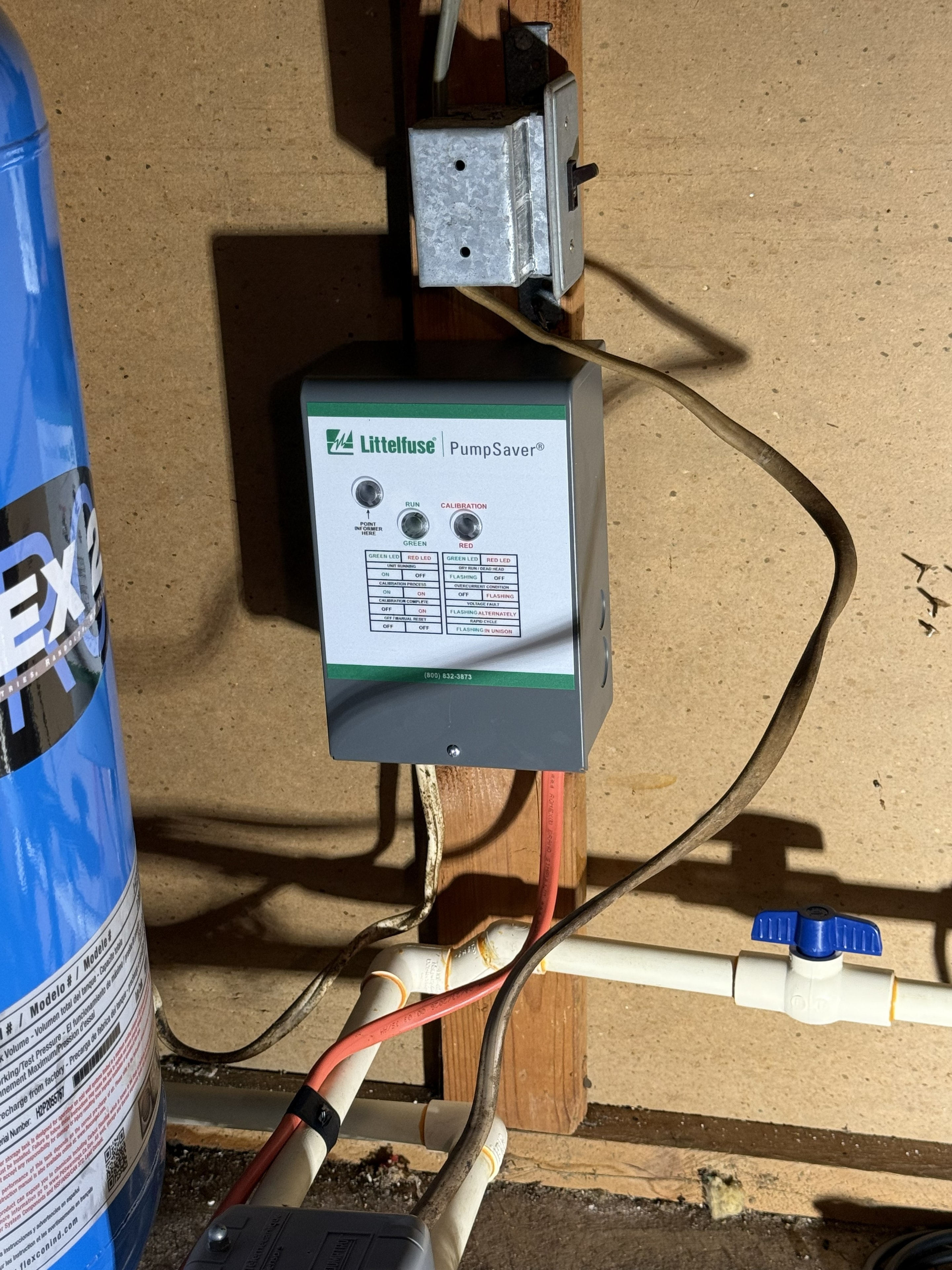 PumpSaver control unit mounted on wall — well water protection system