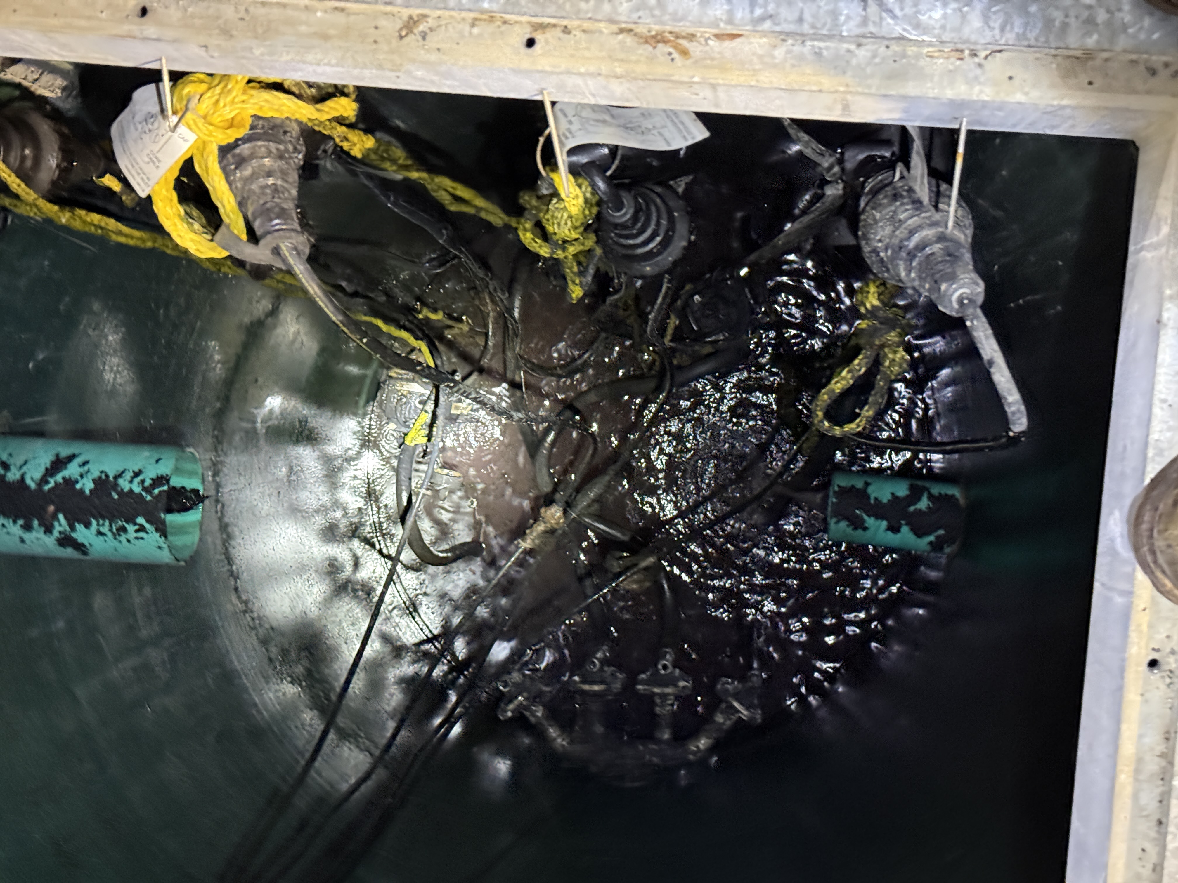 Lift station access port showing the forgotten test ball blocking the sewer line