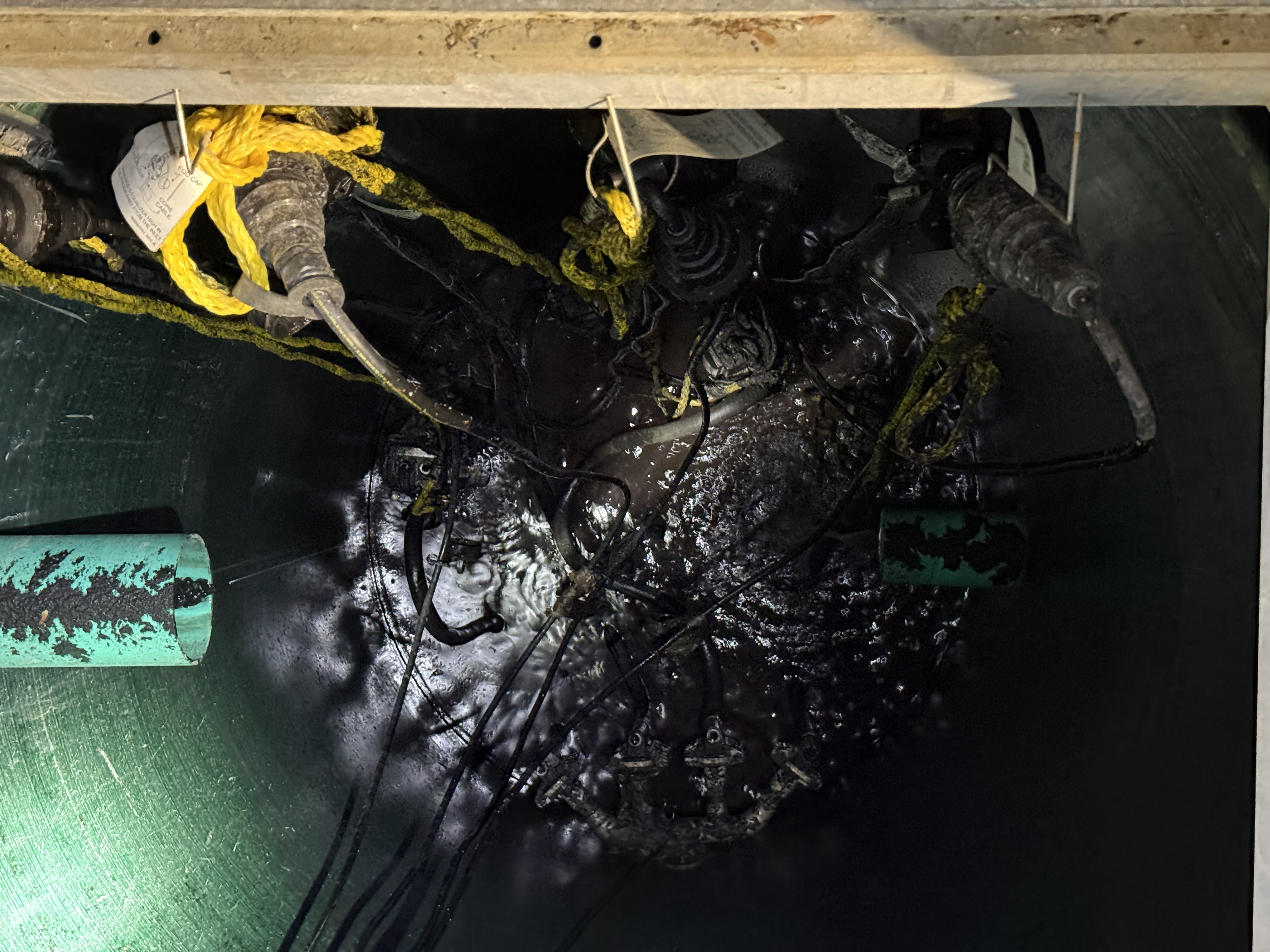 Lift station interior before cleaning — construction debris accumulated since installation