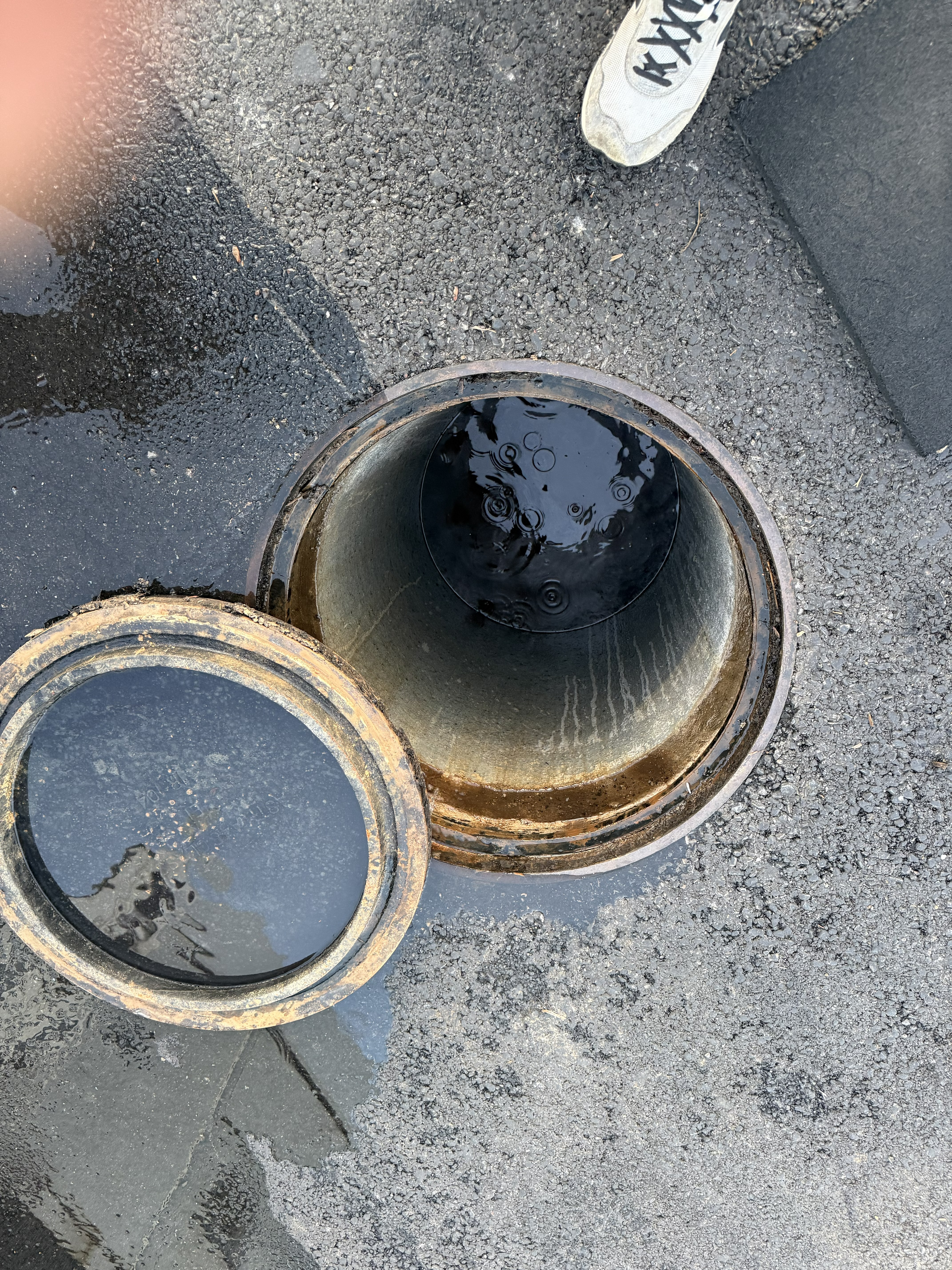 Drain access point with hydro jet hose inserted — clearing the blockage