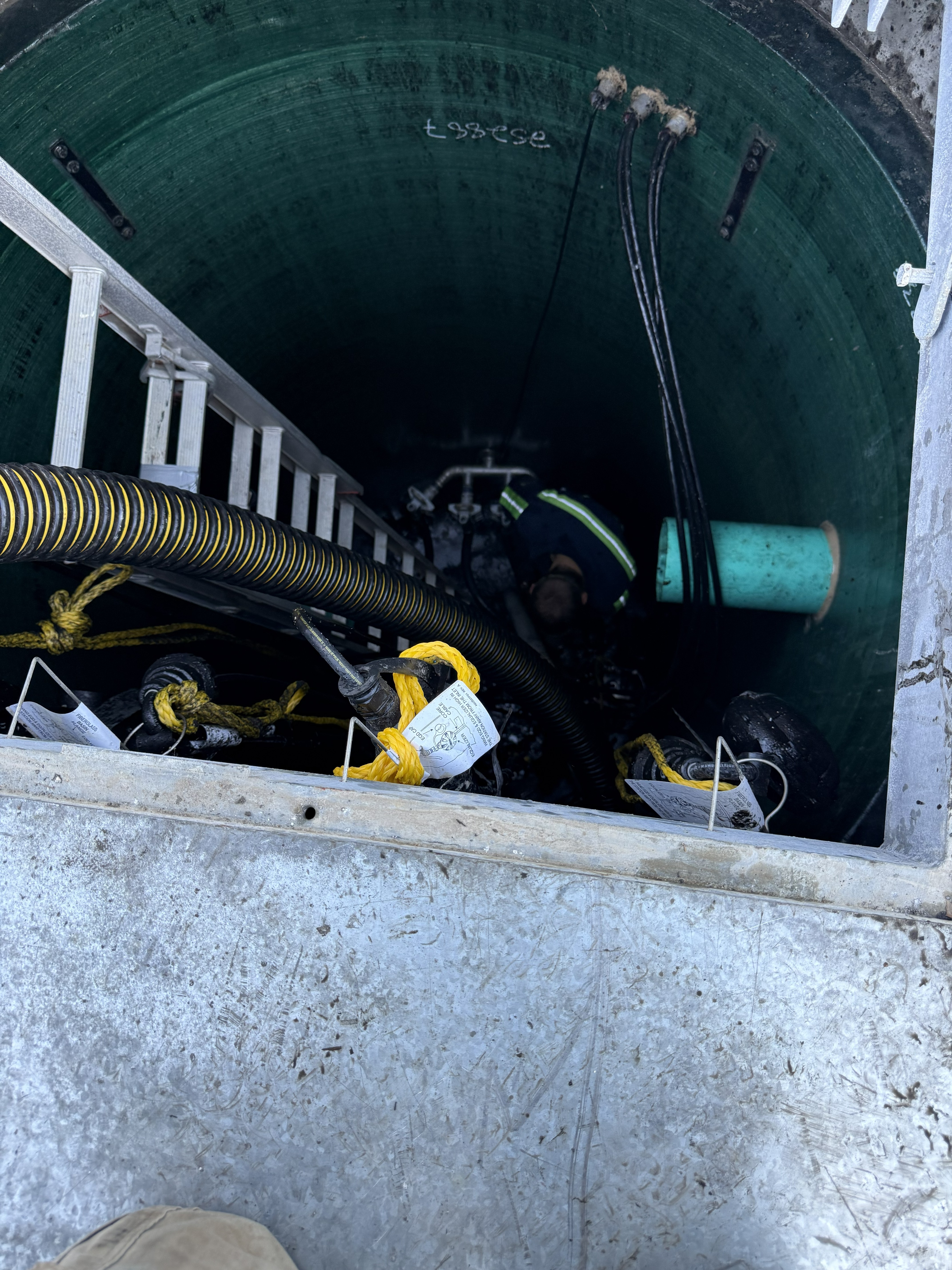 Terry inside the lift station during pump service and wet well cleaning