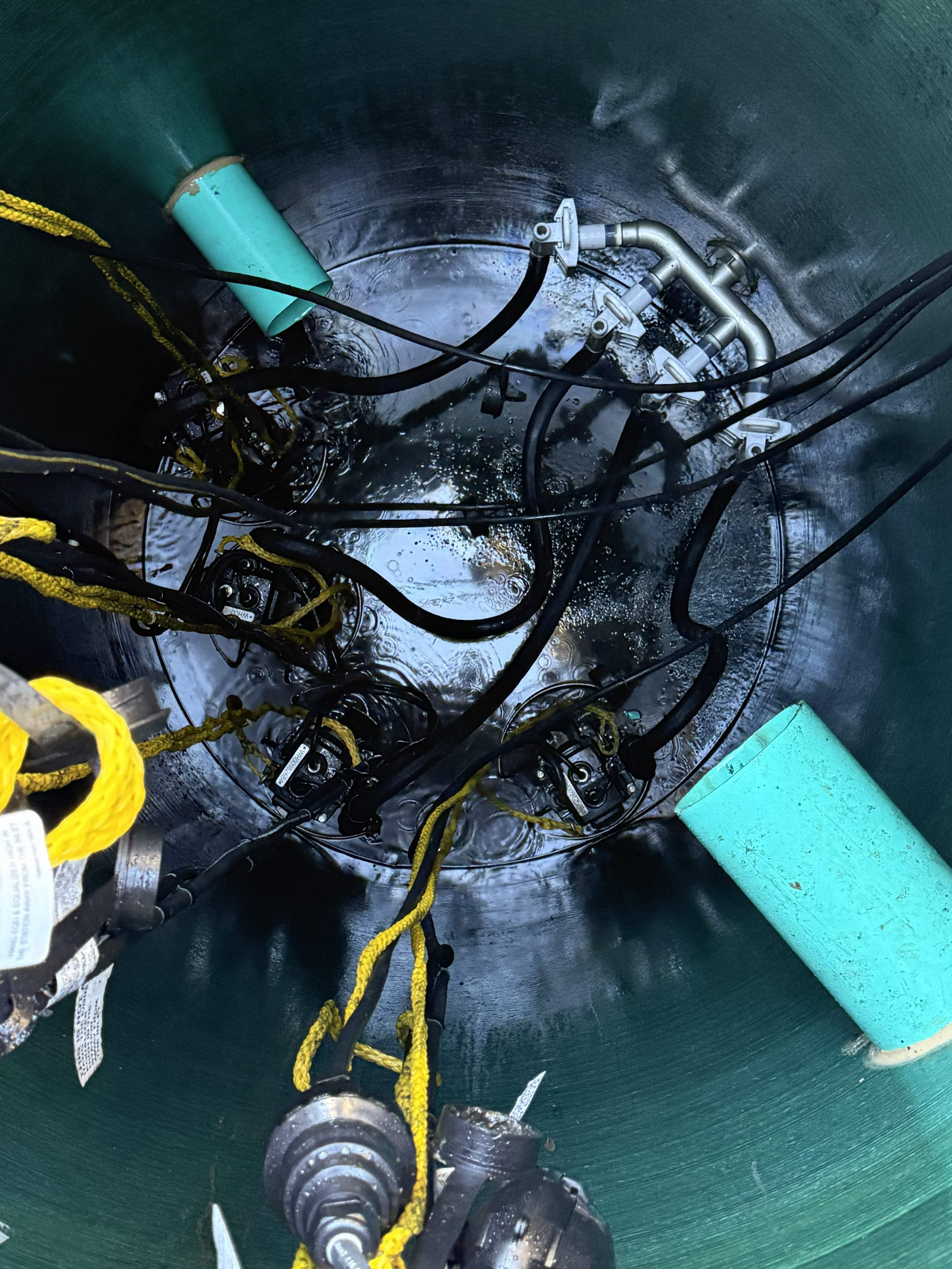 Lift station after cleaning — pumps, floats, and check valves fully visible and operational