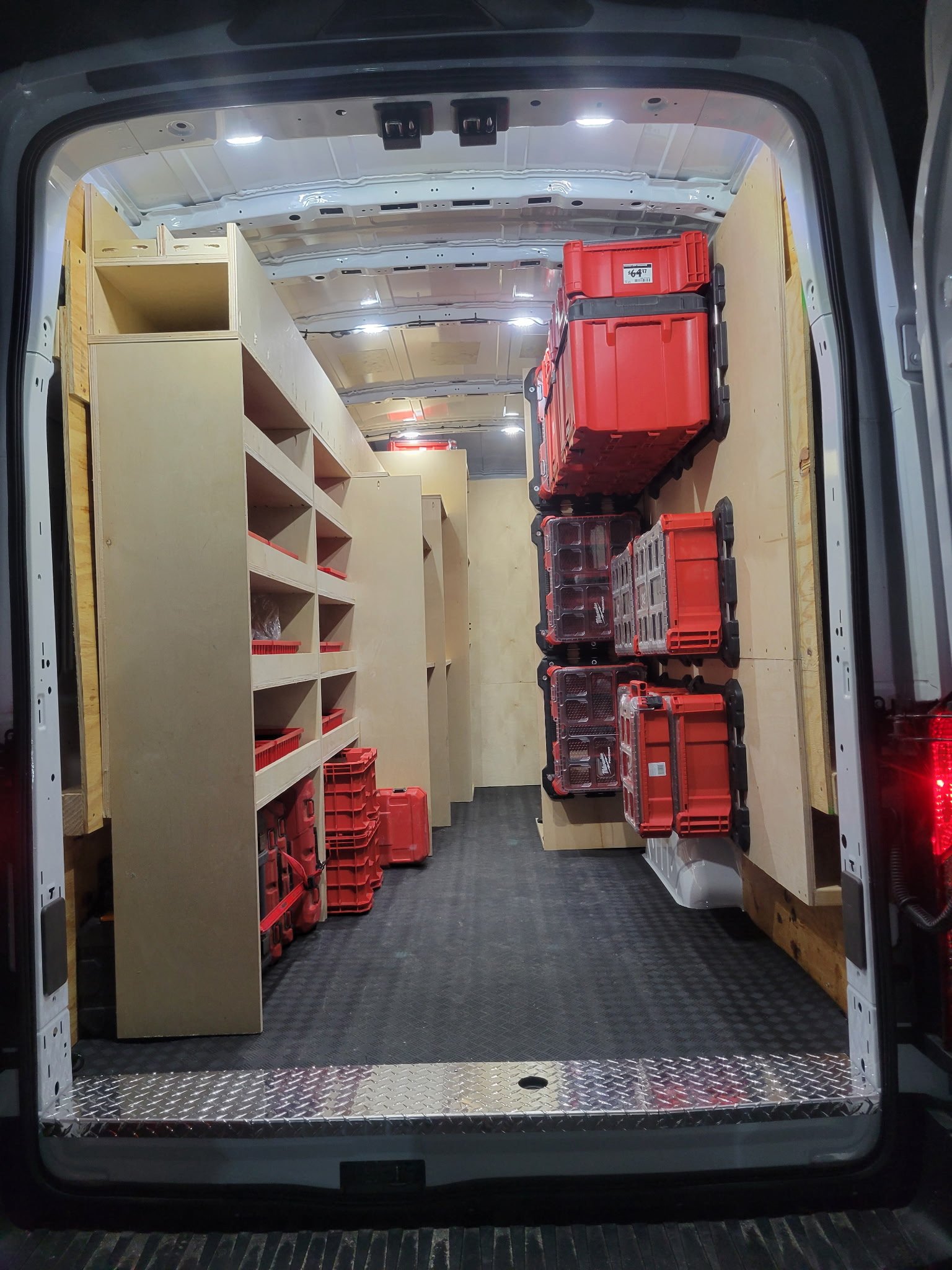Deep Dive Plumbing Maryland van interior — custom wood shelving, Milwaukee tool organization, diamond plate floor